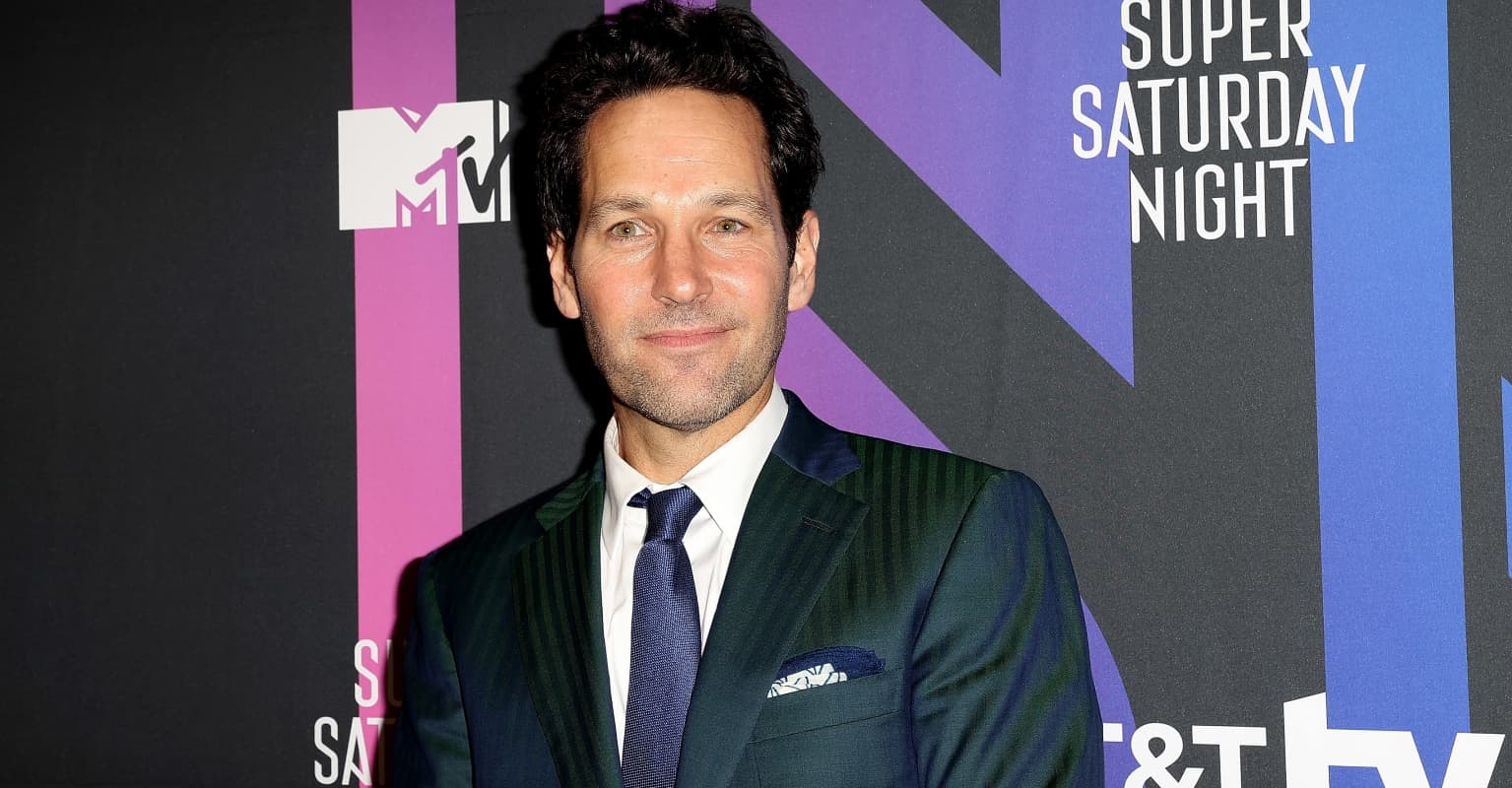Paul Rudd stands out in the rain giving cookies to people waiting to vote